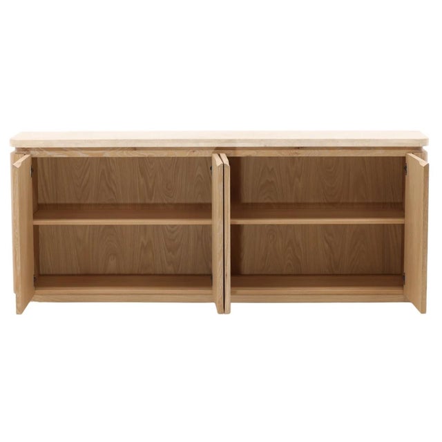 Beautiful sideboard pairing warm natural oak with cream-toned marble, creating a refined balance of texture and material....