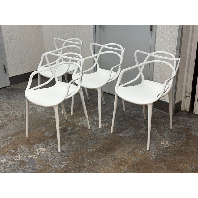 Design Plus Gallery presents a Set of Four Masters Style Dining Chairs. Defined by an interwoven openwork back and fluid...