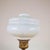 This charming vintage lamp combines the elegance of opal glass with the solidity of metal. The decorative metal base,...