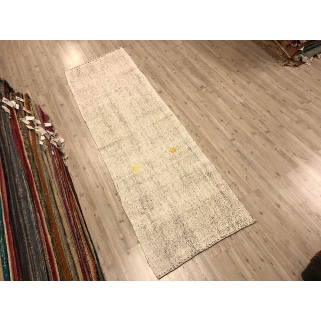 This is a vintage Turkish Anatolian kilim rug from the 1960s. The piece was hand-woven.