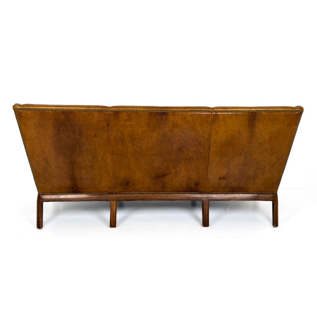 An exceptional Danish sofa designed by Frits Henningsen and executed in Denmark in the 1930s. This piece embodies...