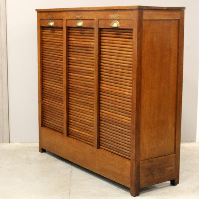 Triple-shutter filing cabinet Made of oak Early 1900s Dimensions: width 142 cm, depth 45 cm, height 132 cm Restored (see...
