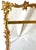An ornate Rococo Revival picture frame featuring an exuberant gilt-metal surround of scrolling acanthus leaves, shell...