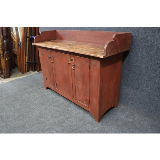 Late 20th Century reproduction Country French/Primitive sideboard with robins egg blue interior. Exterior is a brown/red.