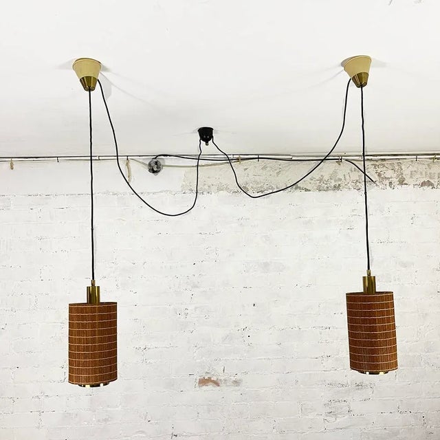 Pair of pendant ceiling lamps manufactured by Estiluz, Barcelona, Spain in the 70s. Cylindrical structure made of teak...