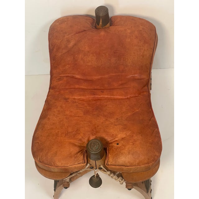 Antique Moroccan Camel Saddle Leather Footstool With Bronze Bell For Sale - Image 4 of 5
