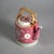 An antique Chinese Famille Rose teapot offers porcelain construction with enameled decoration including floral elements,...