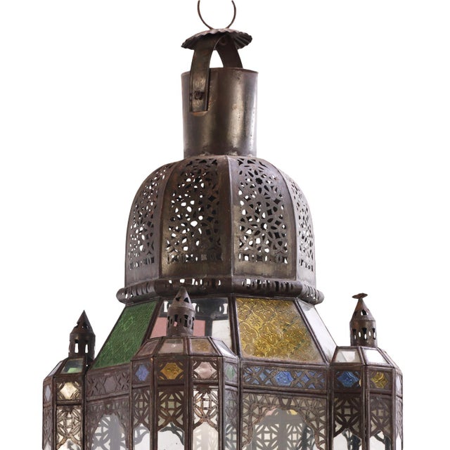 Of tall architectural form, constructed of pierced and hand-tooled tin with an intricate geometric and foliate openwork...