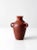 This is a vintage pottery vase. The ruddy red clay vase features three handles.