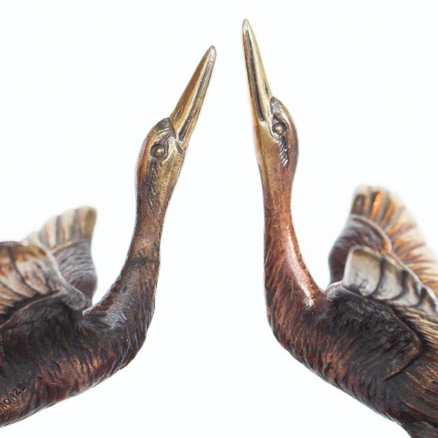 A pair of Art Deco, bronze bookends in the form of two marabou storks. Set over marble plinths. Dimensions: H 10cm, W 3cm...