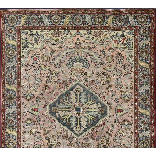 Large antique Oushak rug with floral design in Pink Background and Steel Blue Border, yellow, gray, light brown, red and...