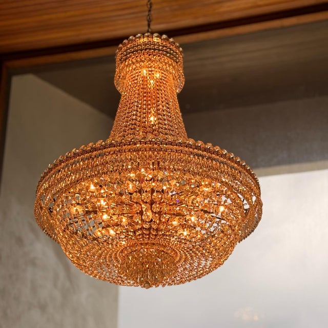 Schonbek crystal chandelier showcasing an opulent Empire silhouette with cascading tiers of radiant crystals and timeless...