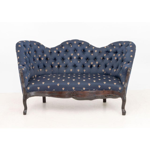 Victorian Button-Tufted Upholstered Walnut Sofa, with bee pattern navy blue upholstery on cabriole legs. 33" H x 52" W x...
