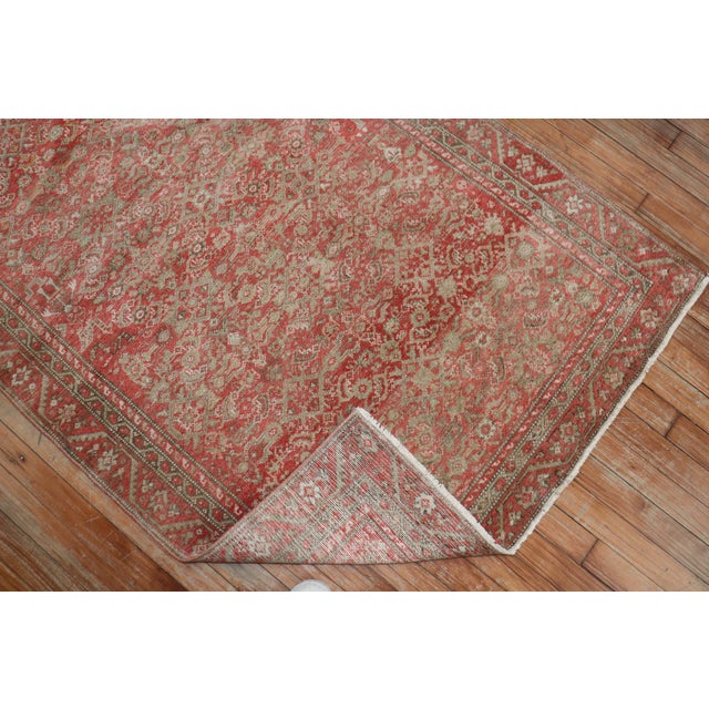 A small size early 20th century Persian Malayer rug with an all-over traditional Herati design in a dominant pink and red...