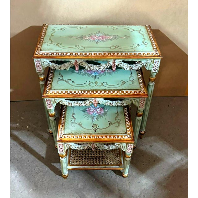 Add a touch of elegant French charm with this beautiful set of three nesting tables, featuring a soft aqua green finish...