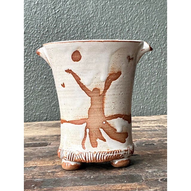 This exceptional vintage studio pottery vase is a masterclass in organic form and primitive expression. Hand-built with a...