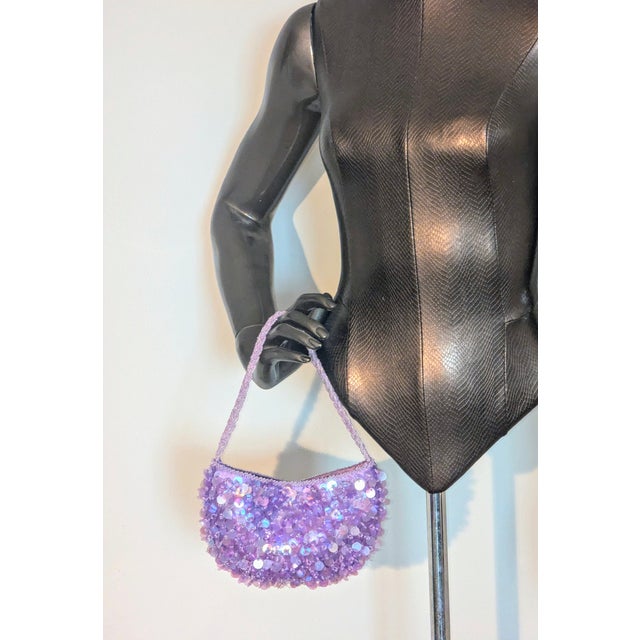 Lavender and lilac colors, the glass beads are in the center on the entire purse like centers of a flower, braided pattern...