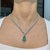 This beautiful statement drop necklace features a 9.81-carat pear-cut natural emerald, set in 14K white gold. It is...