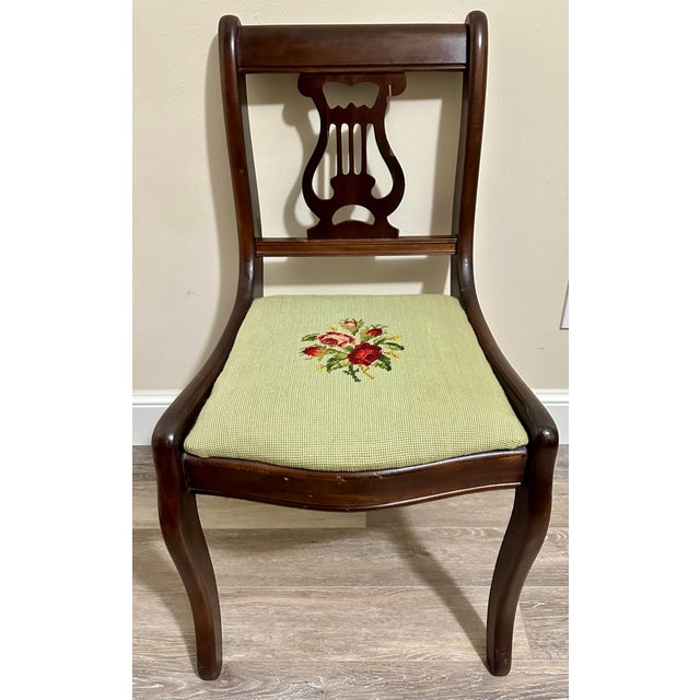 Beautiful mahogany lyre back chair with green needlepoint seat.