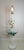 A charming vintage floral toleware floor lamp with an integrated round glass side table. The tall white-painted metal...