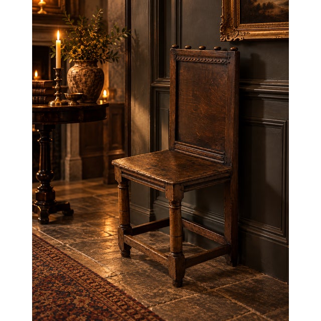 A rare and characterful antique English oak correction chair dating to around 1680, with a tall panelled back, solid oak...
