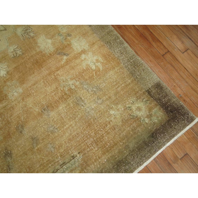 A vintage Turkish gallery size rug in browns and camel.