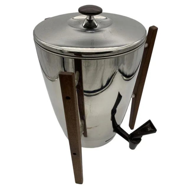 The "Mid-Century chrome coffee maker with teak legs by Regal" is a stylish and functional coffee maker designed with...