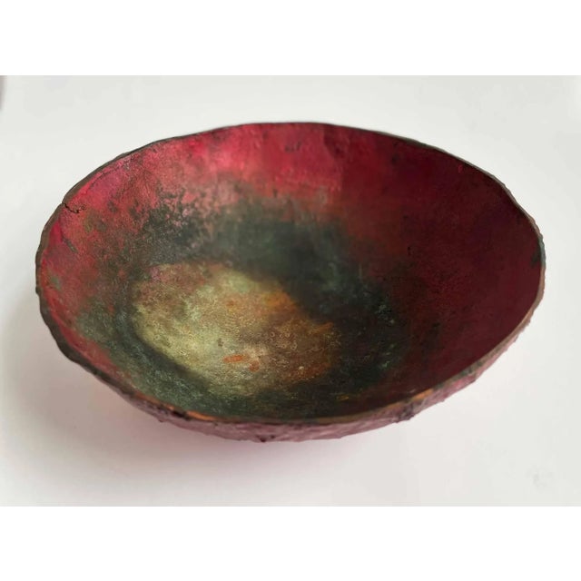 Vintage colorful Raku, artist made metal bowl. An array of matte and metallic reds flow into black then to the gold...