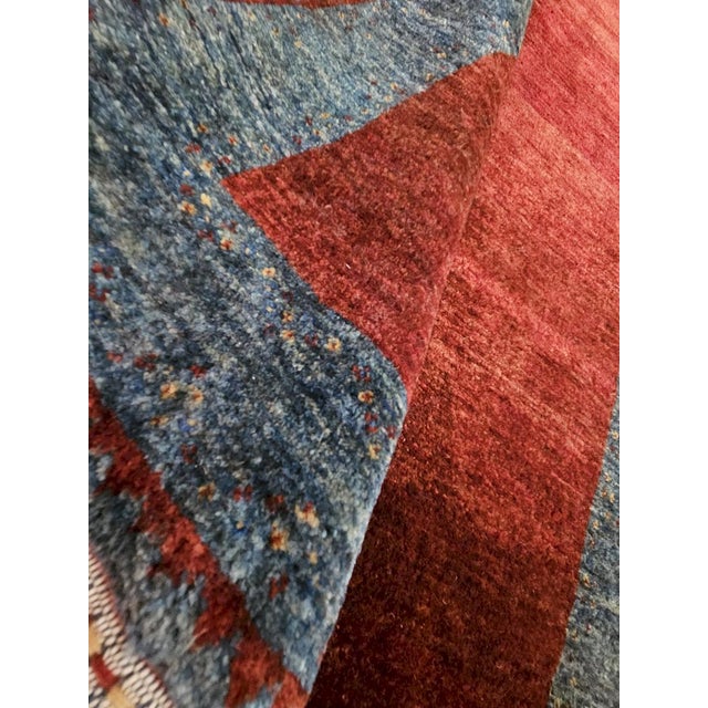 A refined, hand-knotted Kashkuli Sherkat rug made from wool, crafted in Iran according to the finest Qashqai...