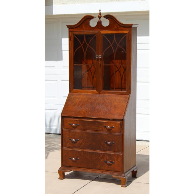 A timeless example of traditional craftsmanship, this vintage Georgian Revival secretary desk and bookcase showcases...