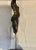 Handsome bronze abstract female sculpture mounted with one single brass rod to a white lacquered wood painted base. It...