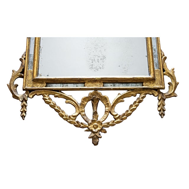 Rectangular wooden mirror with carvings and decorations featuring garlands and floral motifs. Probable origin: early 19th-...