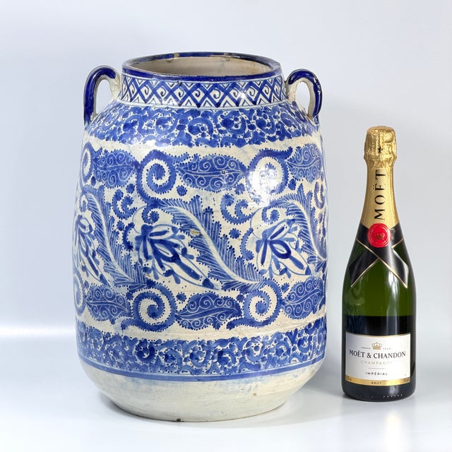 This impressive late 19th to early 20th century Moroccan ceramic vase is hand-painted in deep cobalt blue over a light...