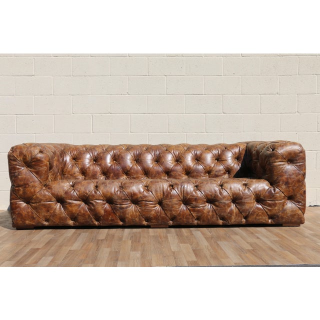 A striking fusion of classic Chesterfield elegance and industrial aviation design, this Aviator-style sofa is a true...