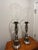 Pair of matching Chapman Hurricane Lamps. These are floor-based candleholders with speckled glass globes as shown. The...