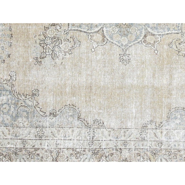 This lavish hand-knotted Persian Tabriz rug adds the perfect touch of elegance to any space. Its intricate design features...