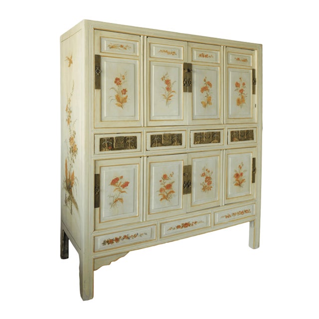Large Chinese 20th-century cabinet with hand-carved and hand-painted floral panels.Large Chinese 20th-century cabinet with...