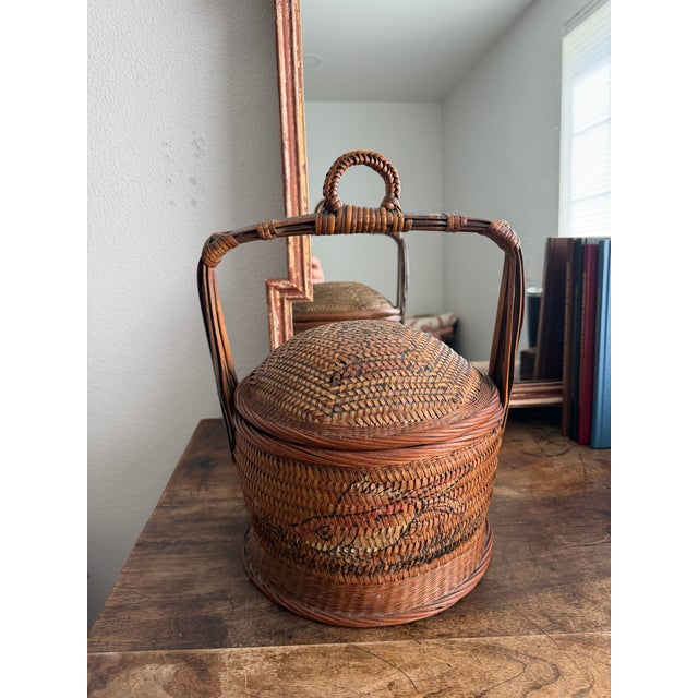 This is a traditional Chinese wedding basket. It is hand painted, though the painting is worn and faded it is still...