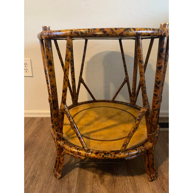 1980’s Vintage Maitland-Smith Faux Bamboo table with embossed leather top in the British Colonial style. This Bi-level...