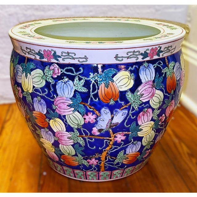 A colorful and vibrant hand painted porcelain fishbowl from China. The rich enamels depict various fruits: pink and light...