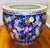 A colorful and vibrant hand painted porcelain fishbowl from China. The rich enamels depict various fruits: pink and light...