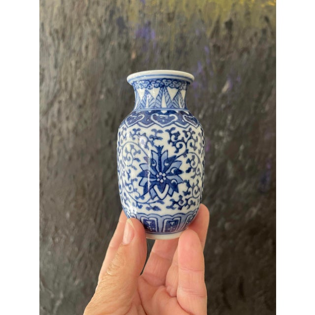 Two pretty Asian pieces, each, in a crisp white ceramic, with a glossy glaze over a rich, royal blue pattern. These are...