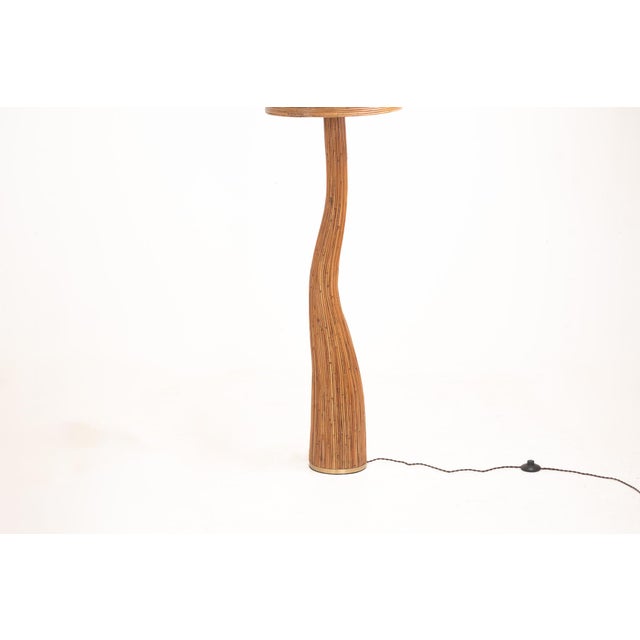 Illuminate your living space with the organic beauty of the Shroom 003 Pencil Reed Floor Lamp. Handcrafted from natural...