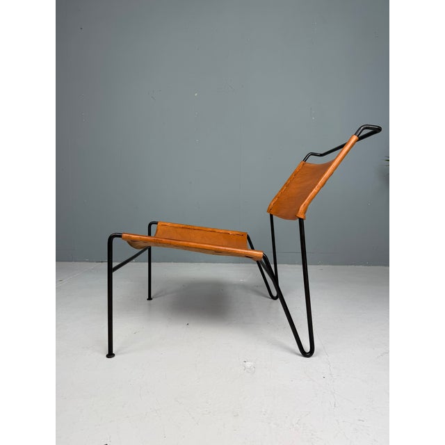 A fantastic lounge chair designed by A. Dolleman, manufactured by Metz & Co in the Netherlands around 1950. The chair has...