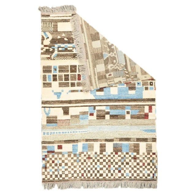 This is a totally crazy rug with bands of large squares, a colorful chessboard, stripes, fences, and an indescribable...