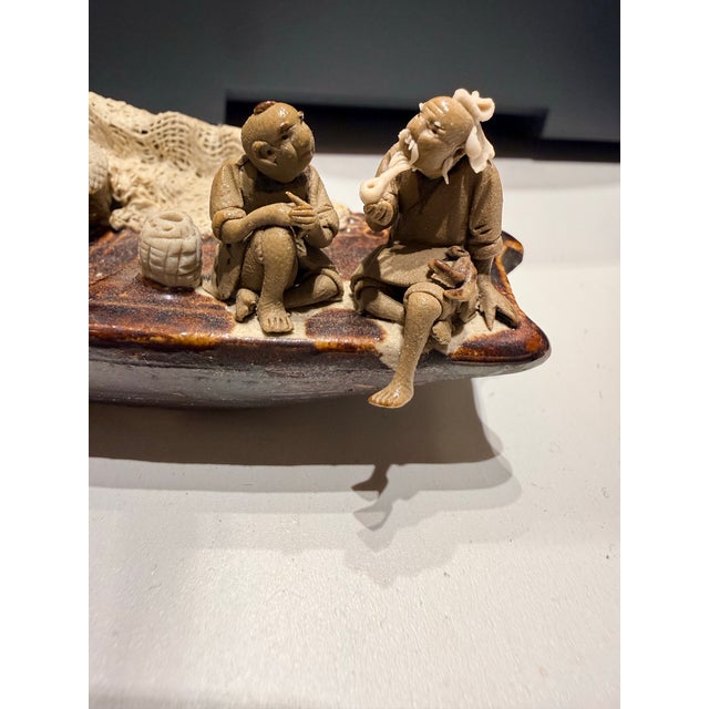 Very detailed Sampan fishing boat with three mudmen fishermen. The men are intricately detailed with beards and clothing....