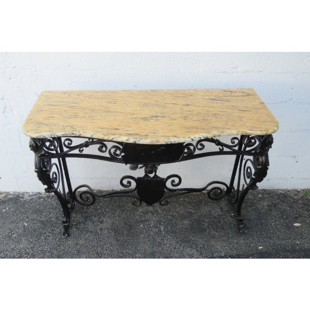 This beautiful Console Table is made out of metal, wrought iron, marble, and is in good condition. This Console Table has...