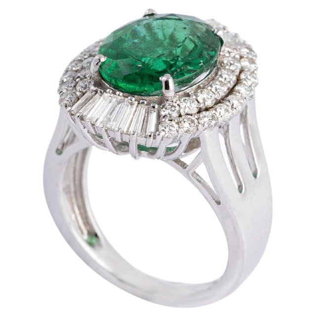 This is a natural Zambian Emerald ring with diamonds and 14k gold. the emeralds are of very high quality and very good...