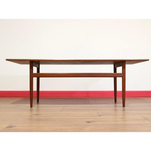 Discover a gorgeous mid century coffee table that exemplifies the timeless elegance of Danish design, featuring a...