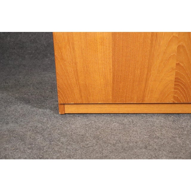 Danish Mid-Century Modern server with fold down top. Ample cabinet storage and flip top bar space with black laminate....